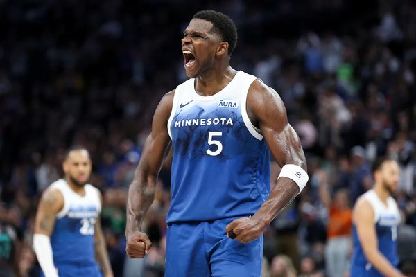 Anthony Edwards celebrating a dunk.